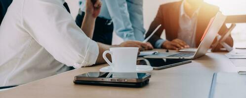 Entrepreneurs and business people conference in modern meeting room, happy multiracial coworkers have fun cooperating working together at office meeting, asian teamwork concept photo