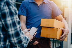 Entrepreneurs Small Business SME Independent men work at home Use smartphones and laptops for commercial checking, online marketing, packing boxes, SME sellers, concept, e-commerce team, online sales photo