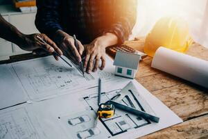 Construction and structure concept of engineer working drawing on blueprint meeting for project working with partner on model building and engineering tools in working site, construction concept photo