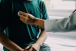 Male patient having consultation with doctor or psychiatrist who working on diagnostic examination on men's health disease or mental illness in medical clinic or hospital mental health service center photo