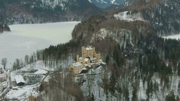 Hohenschwangau Castle and Alpsee Lake in Winter Day. Mountains and Forest. Bavarian Alps, Germany. Aerial View. Wide Shot. Drone is Orbiting video