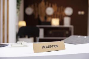 Empty hotel front desk used for check in and registration, booking accommodation in luxury expensive resort. Modern hallway with counter to give key cards to guests at arrival. Close up. photo