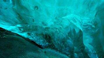 Vatnajokull glacier hiking around cave, icelandic nature inside crevasse with blue transparent ice blocks. Wintry frozen icebergs with covered frost texture, polar icy structure. Handheld shot. photo