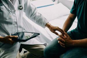 Male patient having consultation with doctor or psychiatrist who working on diagnostic examination on men's health disease or mental illness in medical clinic or hospital mental health service center photo