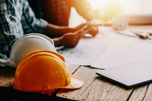 Construction and structure concept of engineer working drawing on blueprint meeting for project working with partner on model building and engineering tools in working site, construction concept photo