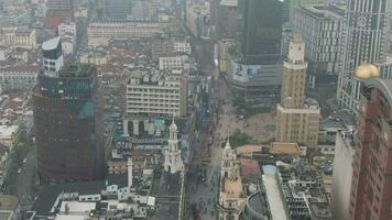 SHANGHAI, CHINA - MARCH 20, 2018 People at Nanjing Road. Pedestrian Street in Huangpu District. Shanghai City, China. Aerial View. Drone Flies Backwards. video