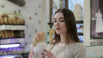 Woman holding pastries in the coffee shop video