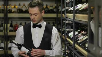 Sommelier choosing a bottle of wine at the wine cellar video