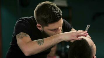 Client during beard grooming in barber shop video