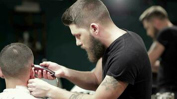 Barber cutting bearded brutal man, reflection in the mirror video