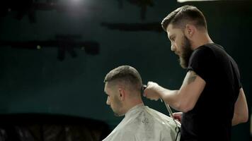 Young man having a haircut with a hair clippers video