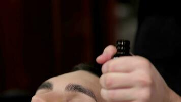 Skillful barber nourishes the skin with vitamins video