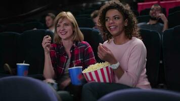 Group of smiling people watching movie video