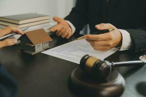 Business and lawyers discussing contract papers with brass scale on desk in office. Law, legal services, advice, justice and law concept picture with film grain effect photo