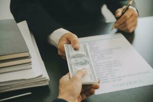 Business and lawyers discussing contract papers with brass scale on desk in office. Law, legal services, advice, justice and law concept picture with film grain effect photo