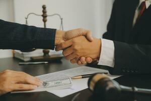 Business and lawyers discussing contract papers with brass scale on desk in office. Law, legal services, advice, justice and law concept picture with film grain effect photo