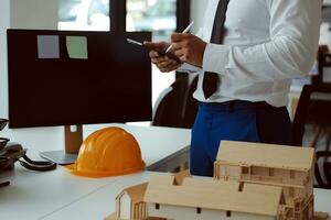 Construction and structure concept of Engineer or architect meeting for project working with partner and engineering tools on model building and blueprint in working site, contract for both companies. photo
