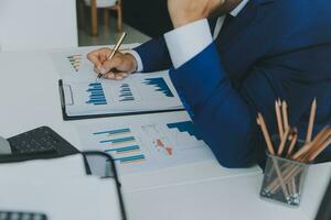 Team of business people working together in the meeting room office, teamwork background charts and graphs banner, double exposure successful teamwork,business planning concept. photo