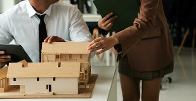 Construction and structure concept of Engineer or architect meeting for project working with partner and engineering tools on model building and blueprint in working site, contract for both companies. photo