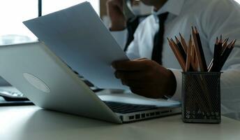 Close up of Business team analyzing income charts and graphs with modern laptop computer. Business analysis and strategy concept. photo