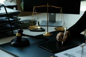 Judge gavel with Justice lawyers having team meeting at law firm in background. Concepts of law. photo