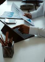 Close up of Business team analyzing income charts and graphs with modern laptop computer. Business analysis and strategy concept. photo