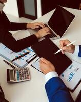 Close up of Business team analyzing income charts and graphs with modern laptop computer. Business analysis and strategy concept. photo