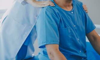 Physiotherapist working with patient in clinic, closeup photo