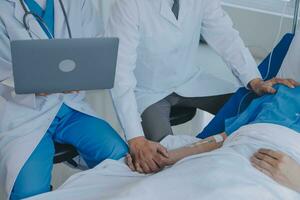 Women Asian doctors hold the patient hand and encourage and provide medical advice While checking the patient health in bed. Concept of Care and compassion, antenatal care, Threatened abortion photo