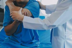 Physiotherapist working with patient in clinic, closeup photo