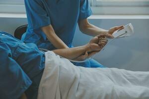 Women Asian doctors hold the patient hand and encourage and provide medical advice While checking the patient health in bed. Concept of Care and compassion, antenatal care, Threatened abortion photo