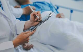 Women Asian doctors hold the patient hand and encourage and provide medical advice While checking the patient health in bed. Concept of Care and compassion, antenatal care, Threatened abortion photo