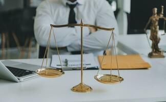 Judge gavel with Justice lawyers having team meeting at law firm in background. Concepts of law. photo