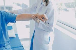 Physiotherapist working with patient in clinic, closeup photo