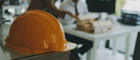 Construction and structure concept of Engineer or architect meeting for project working with partner and engineering tools on model building and blueprint in working site, contract for both companies. photo