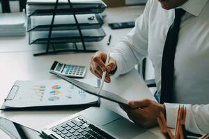 Close up of Business team analyzing income charts and graphs with modern laptop computer. Business analysis and strategy concept. photo