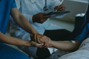 Women Asian doctors hold the patient hand and encourage and provide medical advice While checking the patient health in bed. Concept of Care and compassion, antenatal care, Threatened abortion photo