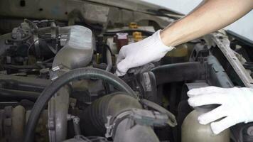 mechanic is closing the oil cap from the car's engine. video