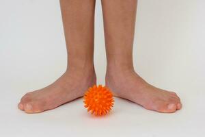 Cropped child legs and spiky needle ball photo