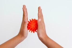 Cropped child hands doing exercise using spiky ball photo