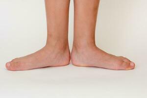 Cropped barefoot child legs photo