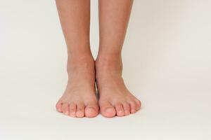 Cropped barefoot child legs photo