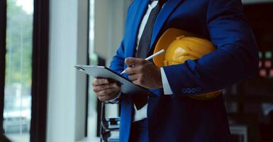 Civil Engineer Hispanic smiling with Constuction backgrounds, use for banner cover. Success in target of project goal Handsome Middle Eastern worker. photo