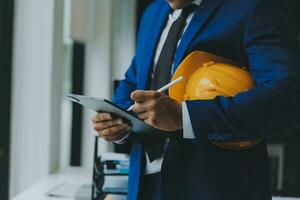 Civil Engineer Hispanic smiling with Constuction backgrounds, use for banner cover. Success in target of project goal Handsome Middle Eastern worker. photo