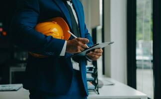 Civil Engineer Hispanic smiling with Constuction backgrounds, use for banner cover. Success in target of project goal Handsome Middle Eastern worker. photo