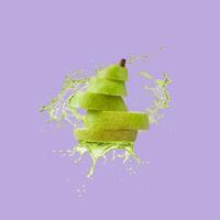 Slices of fresh and ripe pear with splashing pear juice thrown in the air, flying and levitating on a bright violet background. Trendy motion food composition. Creative fruit concept. Pear aesthetic. photo