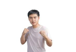 Young handsome man wearing casual t-shirt over white background. Punching fist to fight, aggressive and angry attack, threat and violence, looking forward in boxing fists and ready to attack. photo