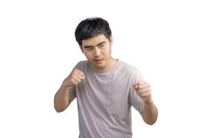 Young handsome man wearing casual t-shirt over white background. Punching fist to fight, aggressive and angry attack, threat and violence, looking forward in boxing fists and ready to attack. photo