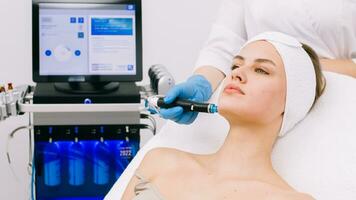 Face Skin Care. Close-up Of Woman Getting Facial Hydro Microdermabrasion Peeling Treatment At Cosmetic Beauty Spa Clinic. Hydra Vacuum Cleaner. Exfoliation, Rejuvenation And Hydratation. Cosmetology. photo