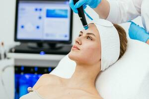 Face Skin Care. Close-up Of Woman Getting Facial Hydro Microdermabrasion Peeling Treatment At Cosmetic Beauty Spa Clinic. Hydra Vacuum Cleaner. Exfoliation, Rejuvenation And Hydratation. Cosmetology. photo